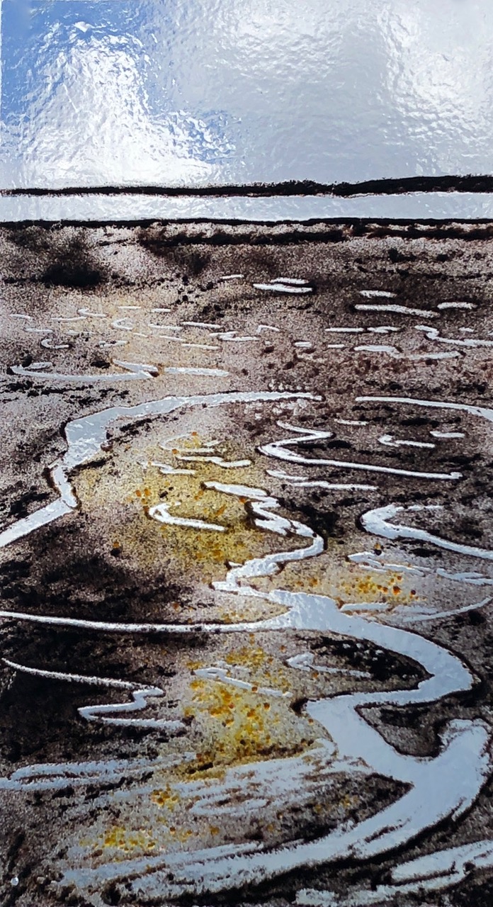 A picture of a glass panel depicting an estuary at low tide