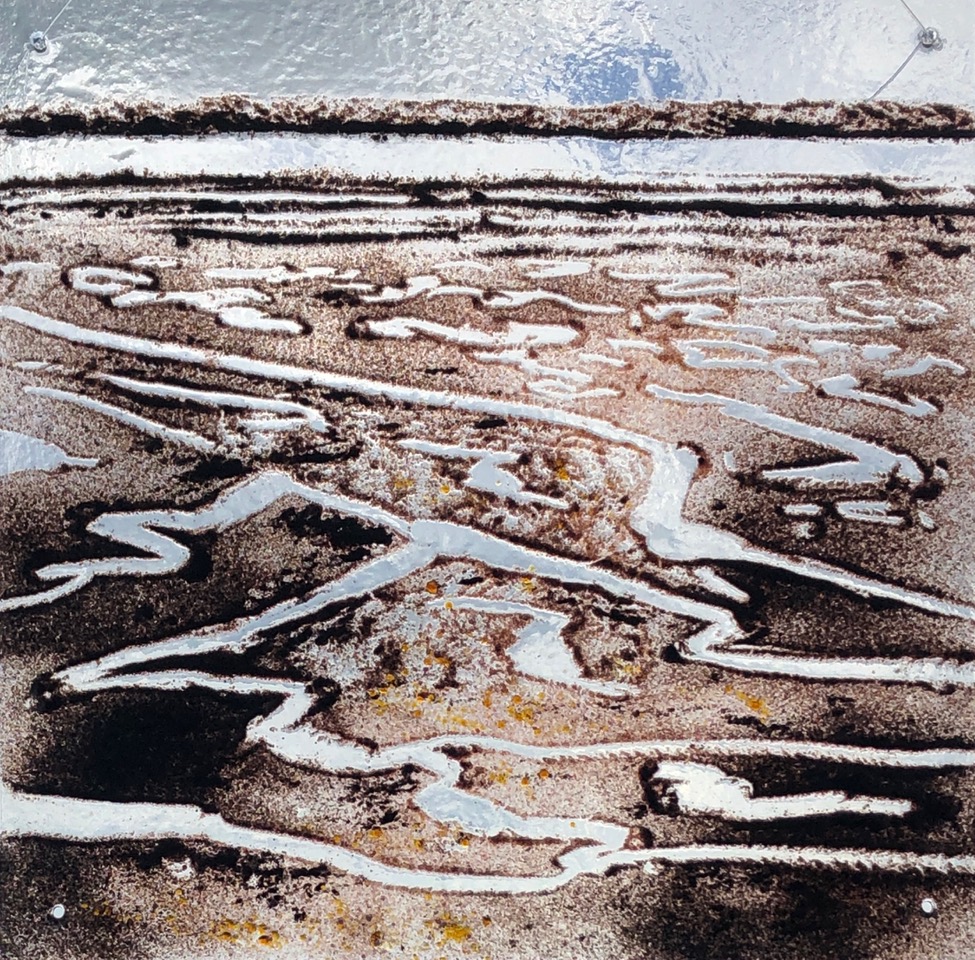 A picture of a glass panel depicting an estuary at low tide